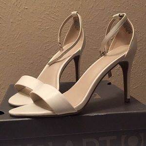 White, ankle strap, open toed heels.